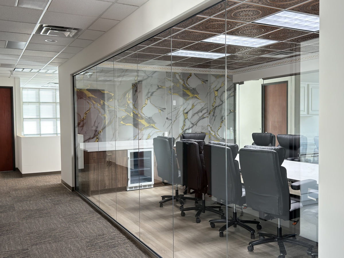 Modern office conference room with glass walls and a meeting table before window film application which provides no privacy